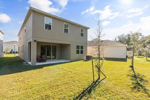 an aerial view of residential house with outdoor space and parking