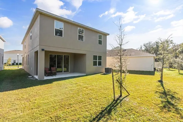 an aerial view of residential house with outdoor space and parking