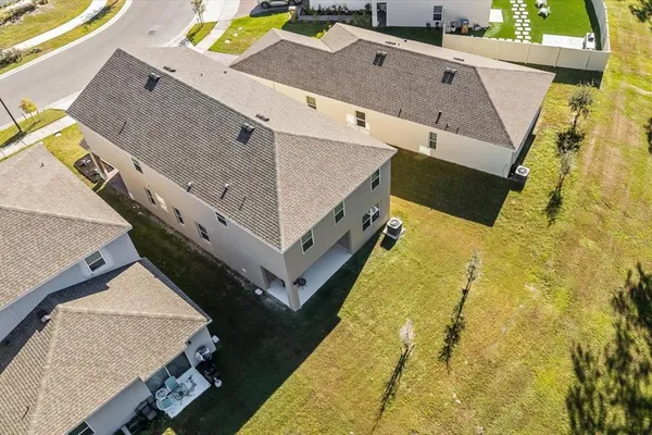 an aerial view of residential houses with outdoor space