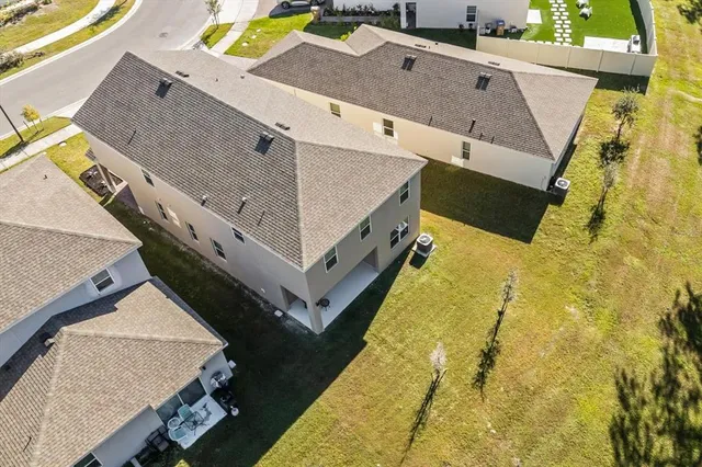 an aerial view of residential houses with outdoor space