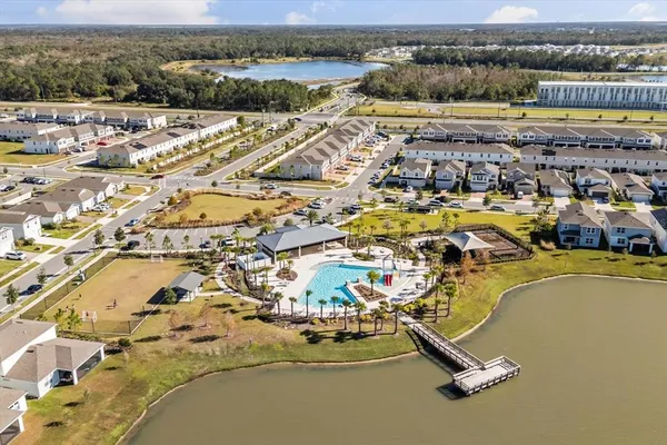 an aerial view of residential building and lake