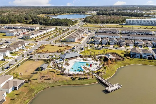 an aerial view of residential building and lake