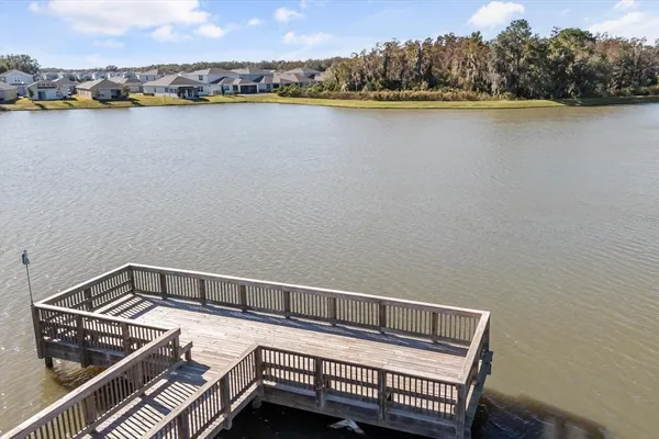 an aerial view of a house with a yard and lake view