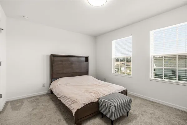 a bedroom with a bed and window