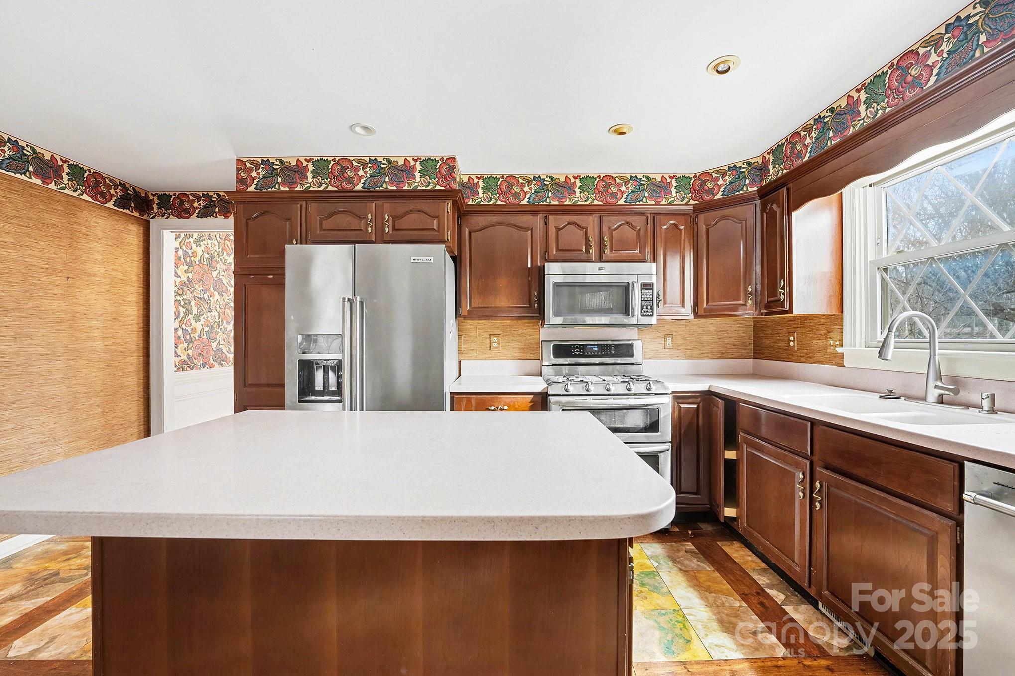 217 Nottingham Drive Huntersville, NC 28078 - Photo 20 of 41 a kitchen with stainless steel appliances a sink stove and refrigerator
