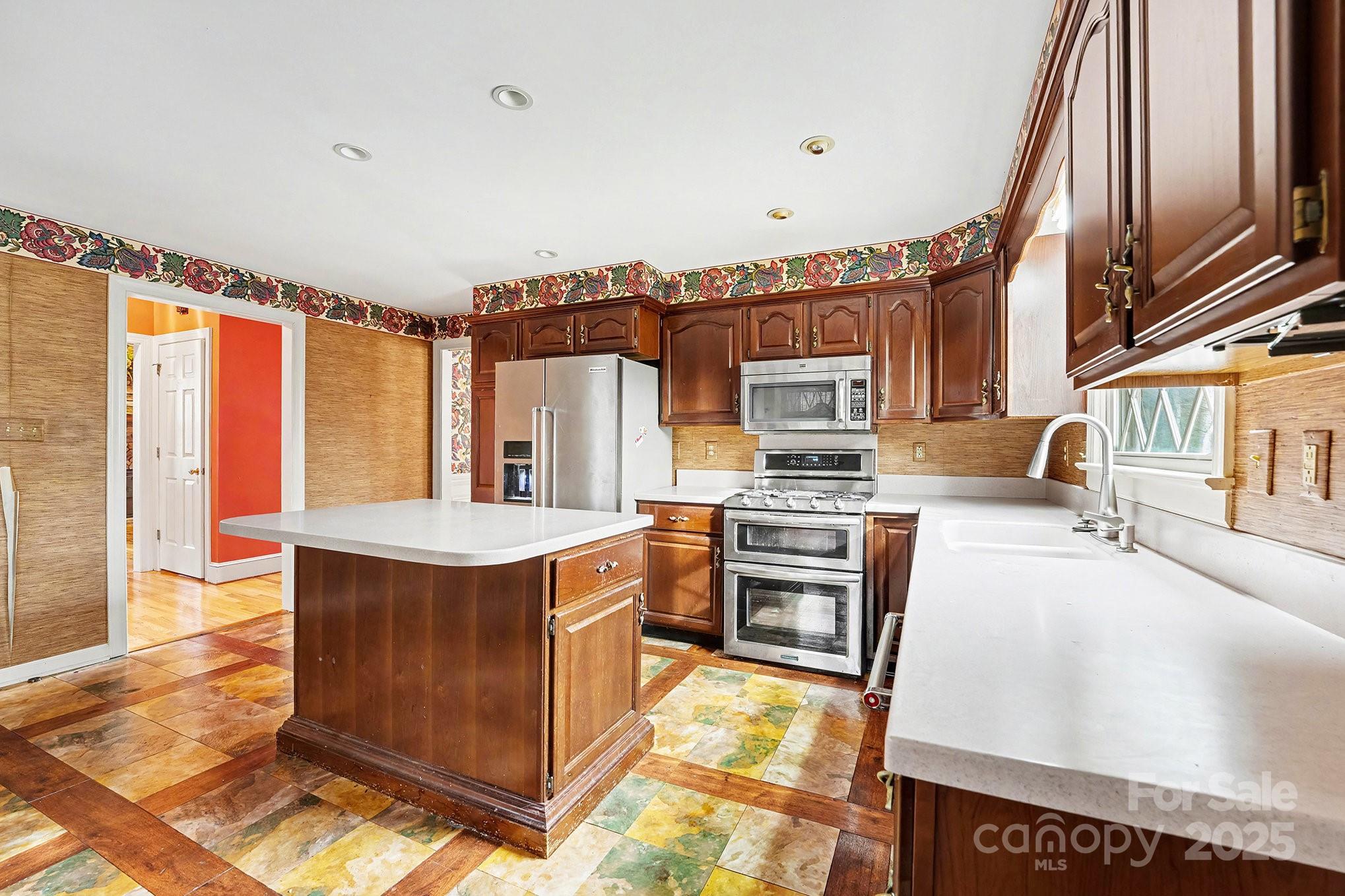217 Nottingham Drive Huntersville, NC 28078 - Photo 21 of 41 a kitchen with stainless steel appliances granite countertop a stove a sink and a refrigerator