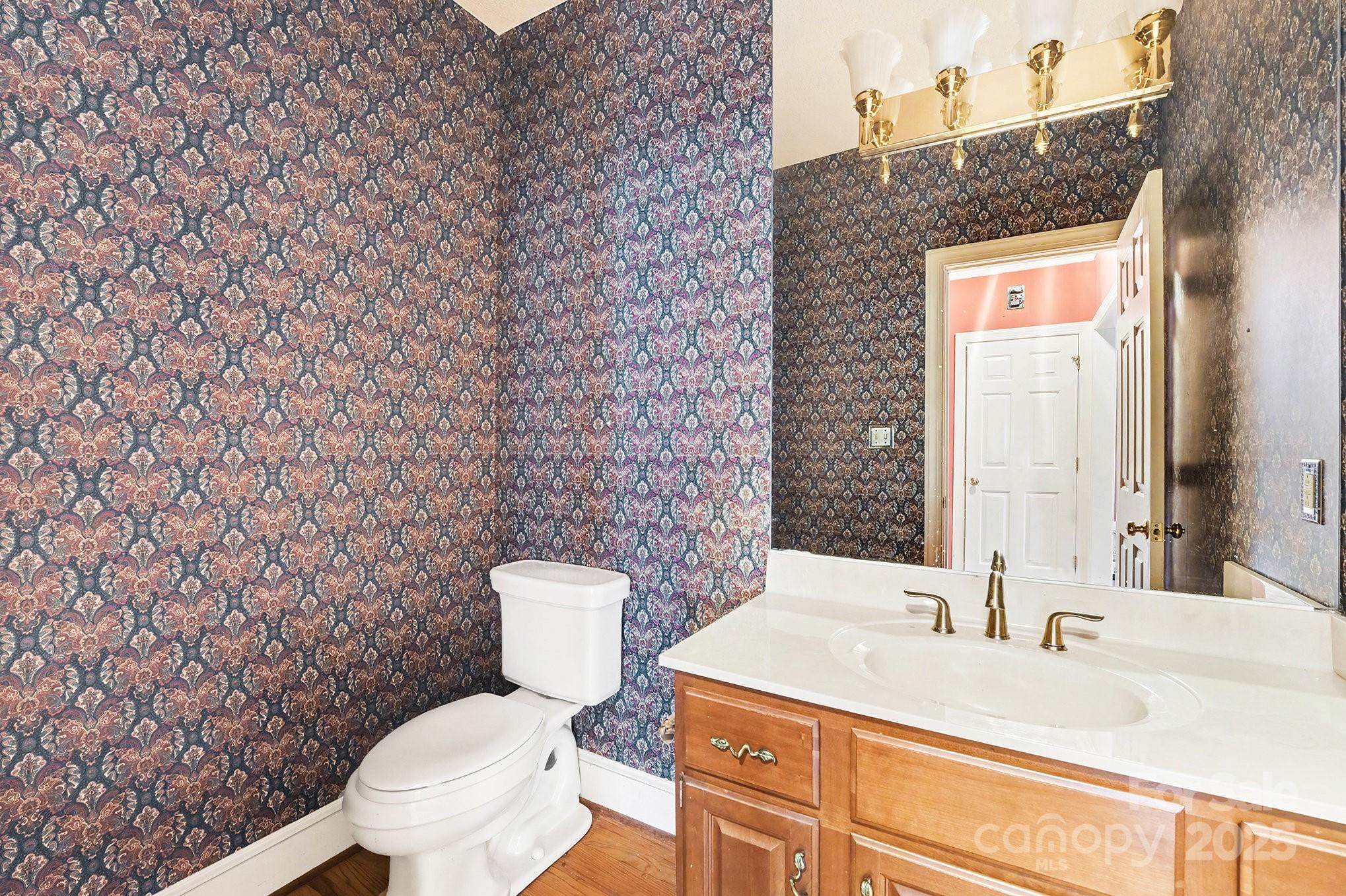 217 Nottingham Drive Huntersville, NC 28078 - Photo 22 of 41 a bathroom with a toilet a sink and mirror