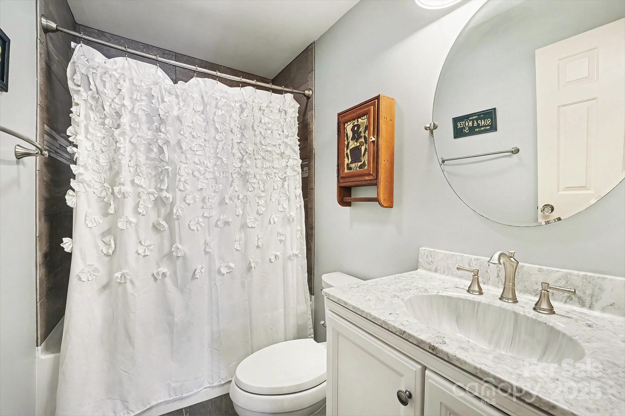 217 Nottingham Drive Huntersville, NC 28078 - Photo 30 of 41 a bathroom with a granite countertop sink and a mirror