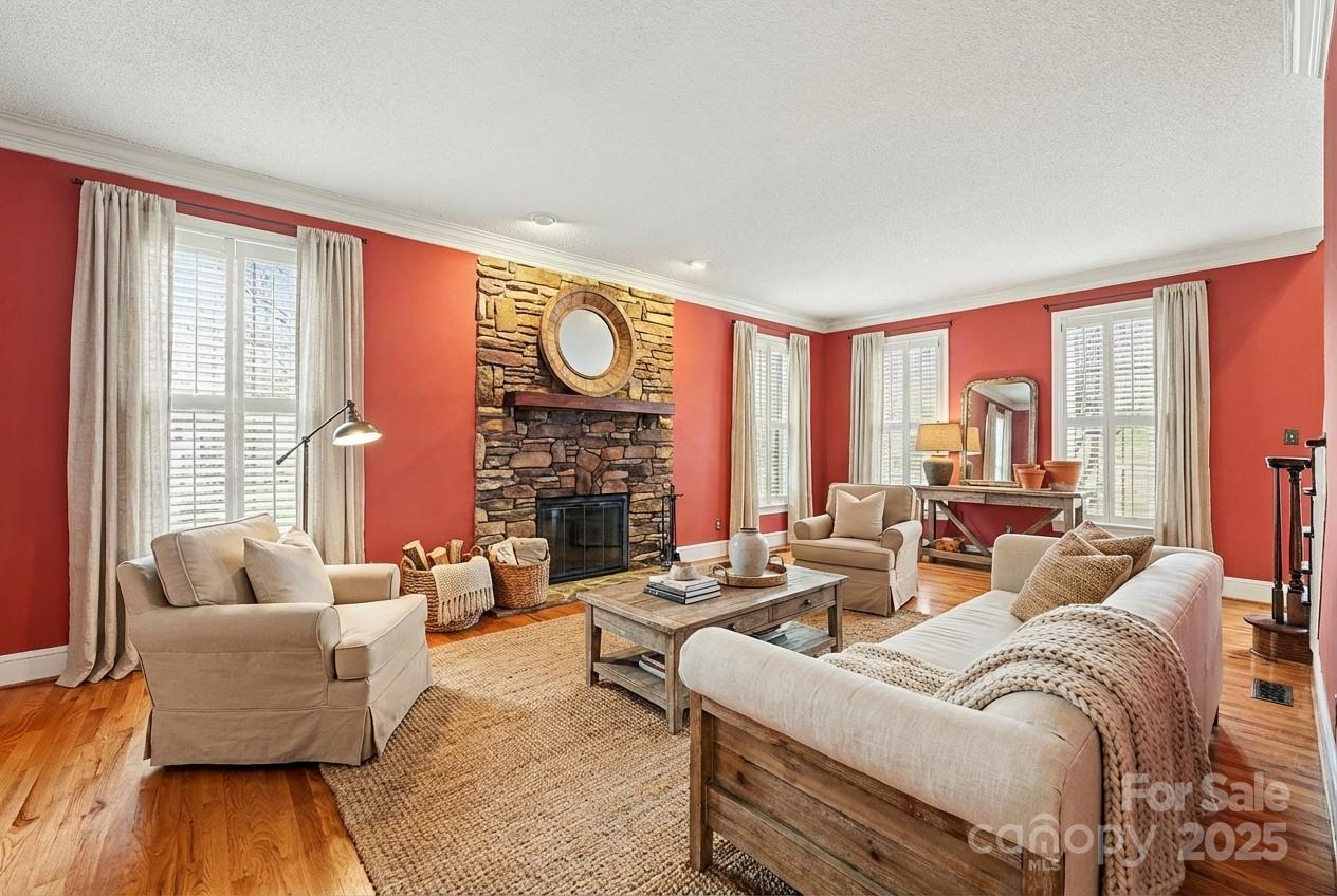 217 Nottingham Drive Huntersville, NC 28078 - Photo 3 of 41 a living room with fireplace furniture and a large window