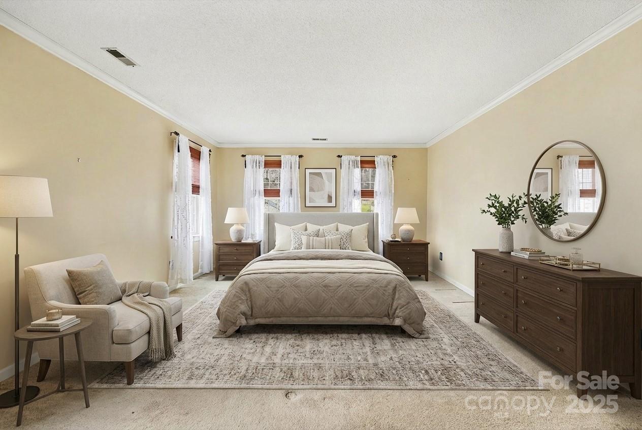 217 Nottingham Drive Huntersville, NC 28078 - Photo 5 of 41 a spacious bedroom with a bed a couch and a potted plant on the dresser