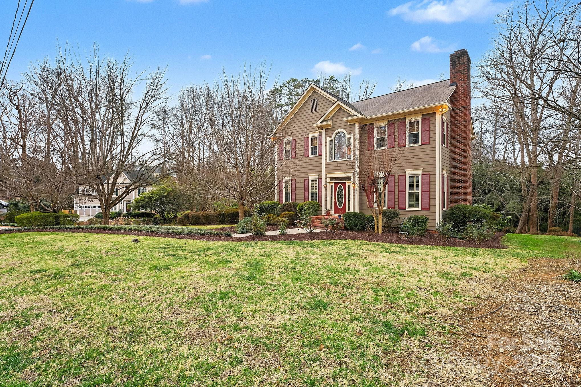 217 Nottingham Drive Huntersville, NC 28078 - Photo 8 of 41 a view of a big house with a big yard and large trees