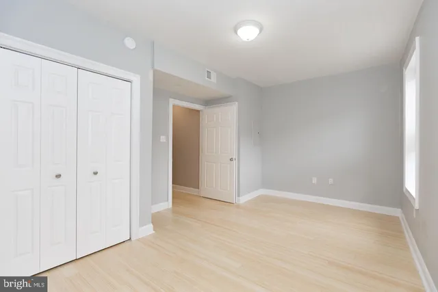 a view of washer and dryer with door in the background