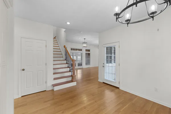 a view of a room with wooden floor and staircase