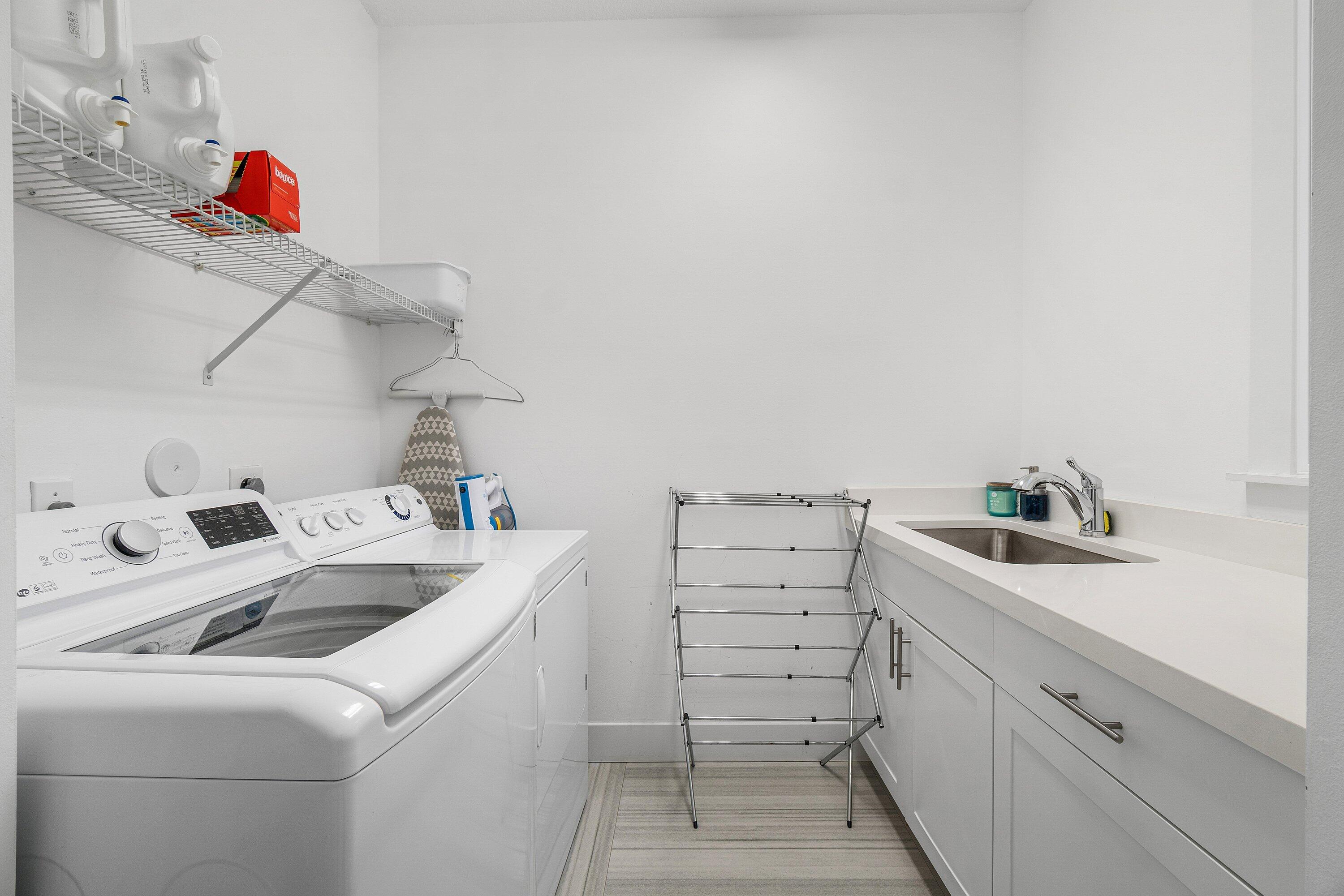 2404 Northwest 67th Street Boca Raton, FL 33496 - Photo 16 of 74 a utility room with dryer and washer