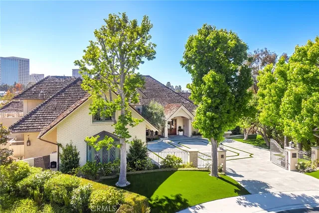 an aerial view of a house with a garden and lake view