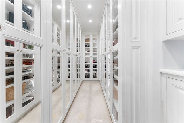 a view of a swimming pool with lawn chairs under an umbrella