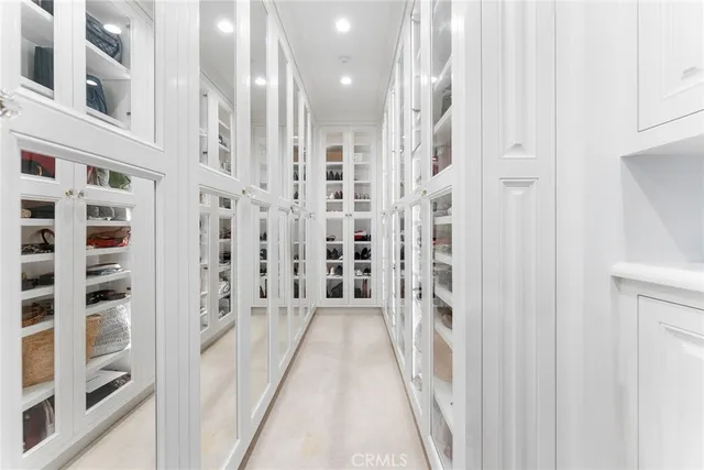a view of a swimming pool with lawn chairs under an umbrella