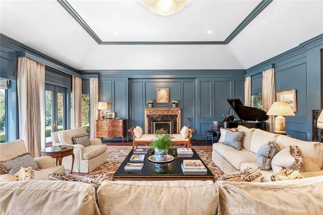 a living room with furniture a rug and a large window