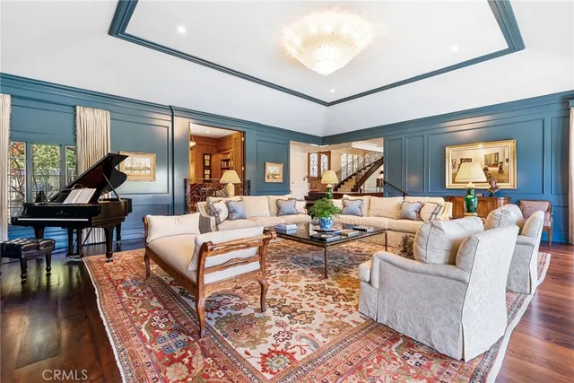 a living room with furniture a rug and a chandelier
