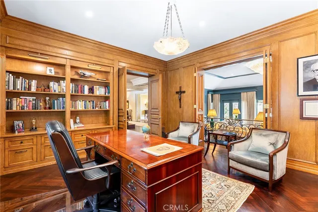 a dining room with furniture a chandelier and wooden floor