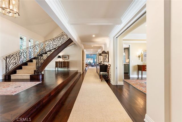 a kitchen with a stove a sink a kitchen island with wooden cabinets