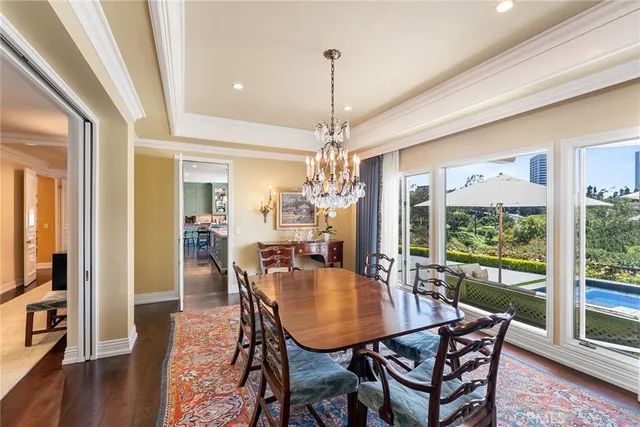 a view of a dining room with furniture large windows and wooden floor