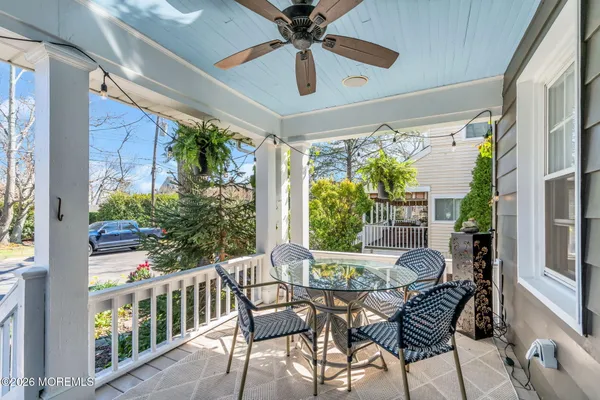 a view of backyard with outdoor seating and plants