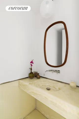 a kitchen with white cabinets and sink