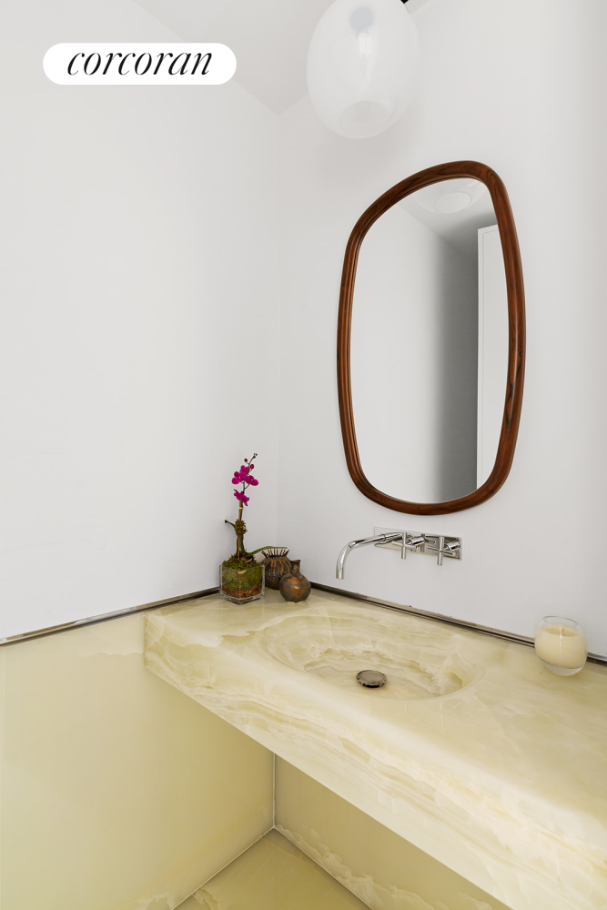 60 East 86th Street, Unit 16 Manhattan, NY 10028 - Photo 9 of 12 a bathroom with a sink and a mirror