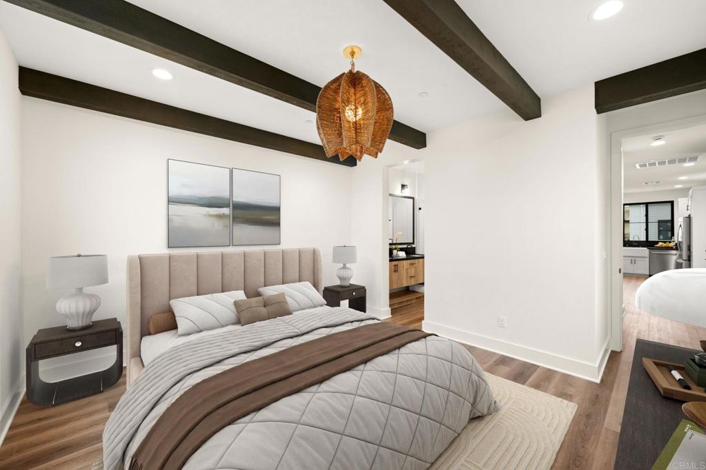 1303 Bergamo, Unit 201 Encinitas, CA 92024 - Photo 11 of 42 a bedroom with a bed and a chandelier
