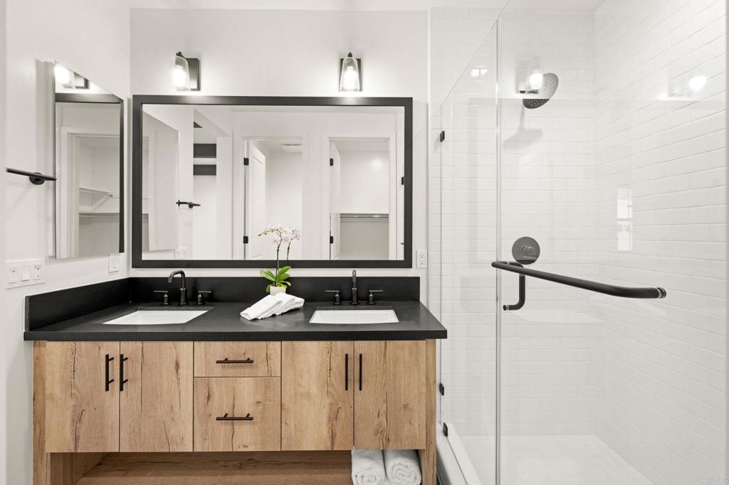 1303 Bergamo, Unit 201 Encinitas, CA 92024 - Photo 12 of 42 a bathroom with a granite countertop sink and a mirror