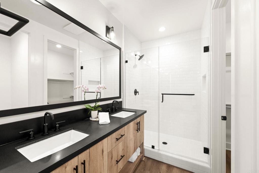 1303 Bergamo, Unit 201 Encinitas, CA 92024 - Photo 14 of 42 a bathroom with a double vanity sink a mirror and shower