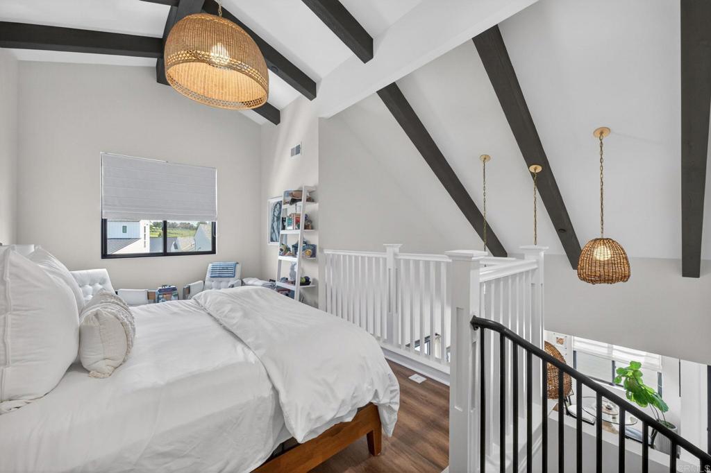 1303 Bergamo, Unit 201 Encinitas, CA 92024 - Photo 15 of 42 a bedroom with bed and wooden floor