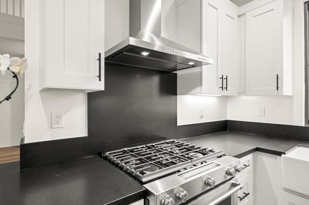 1303 Bergamo, Unit 201 Encinitas, CA 92024 - Photo 19 of 42 a kitchen with a stove and a cabinet