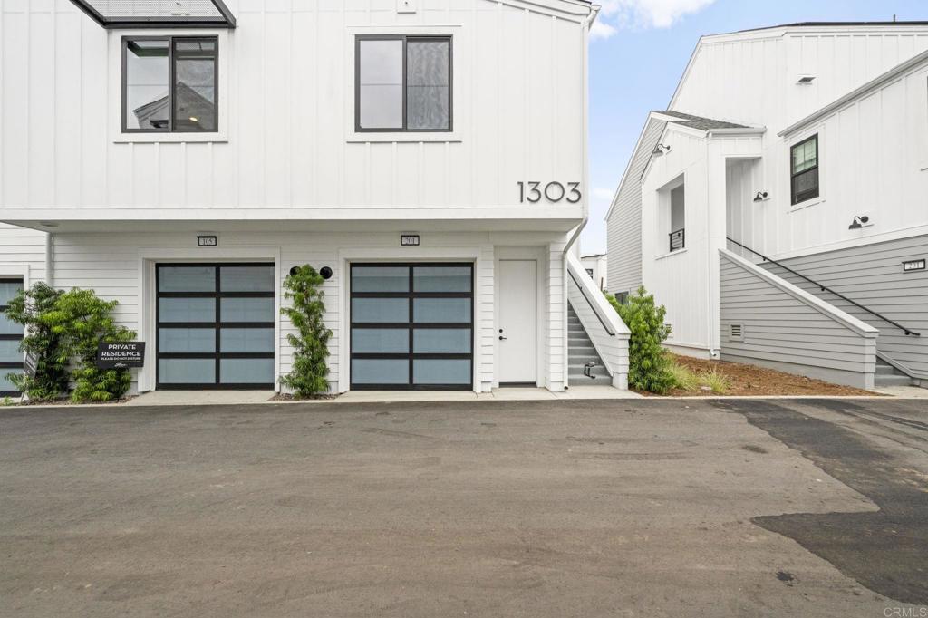 1303 Bergamo, Unit 201 Encinitas, CA 92024 - Photo 23 of 42 a front view of a house with a yard and garage