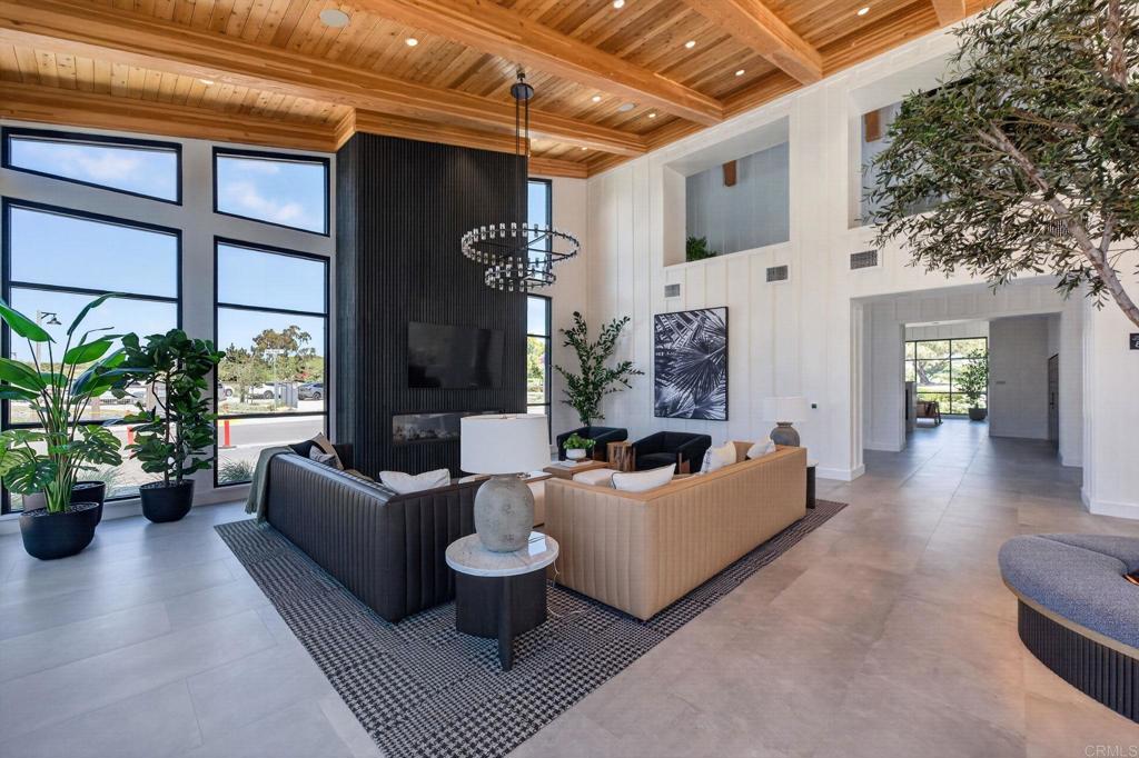 1303 Bergamo, Unit 201 Encinitas, CA 92024 - Photo 35 of 42 a living room with fireplace furniture and a large window