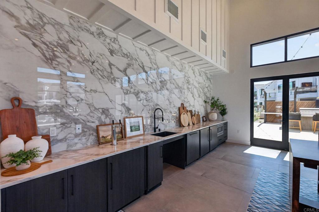 1303 Bergamo, Unit 201 Encinitas, CA 92024 - Photo 38 of 42 a kitchen with stainless steel appliances wooden cabinets and wooden floor