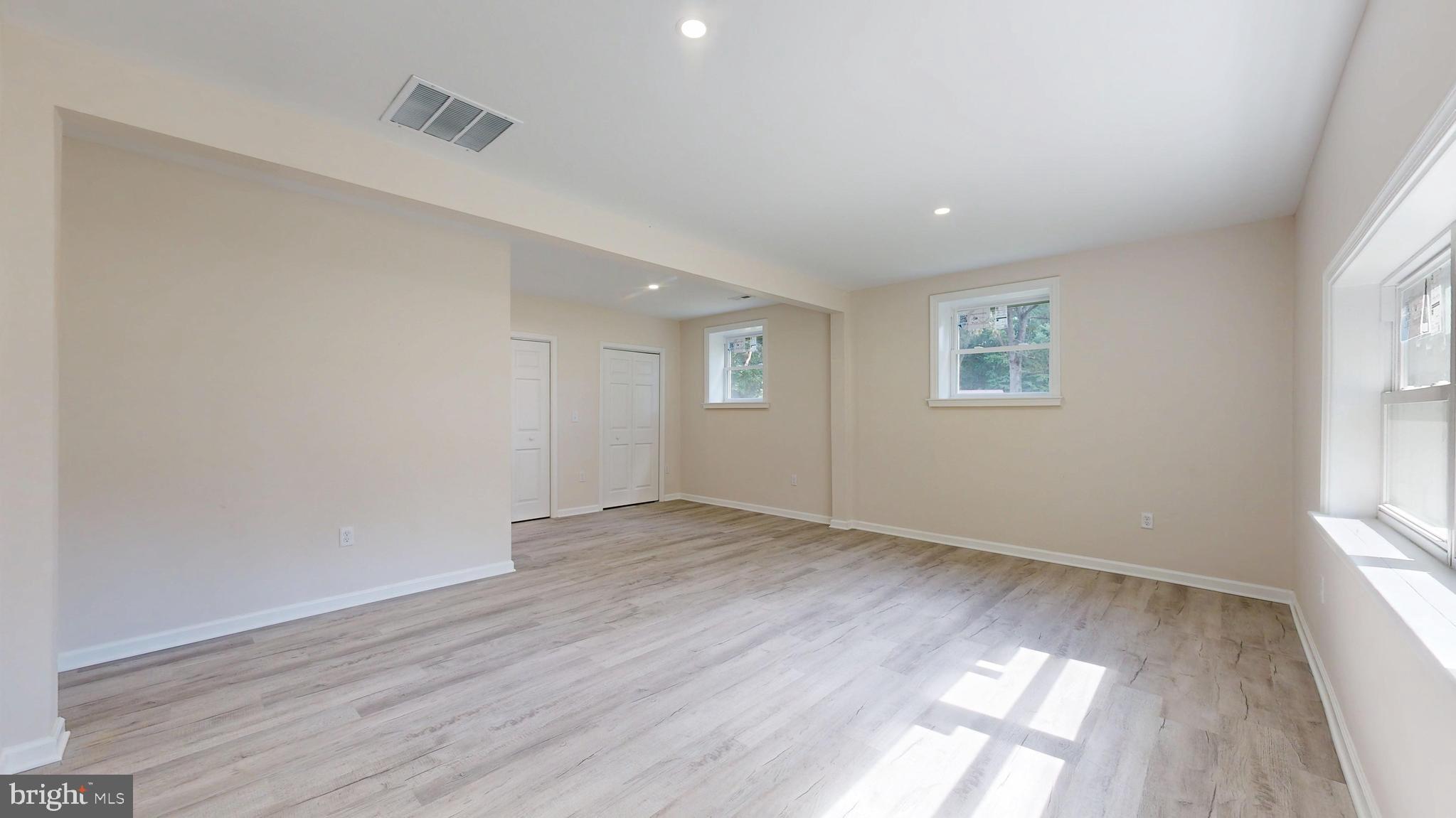 4640 Mahan Corner Road Marydel, DE 19964 - Photo 11 of 29 an empty room with wooden floor and windows