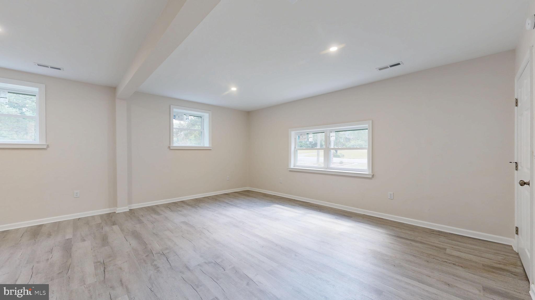 4640 Mahan Corner Road Marydel, DE 19964 - Photo 13 of 29 a view of an empty room with wooden floor and a window