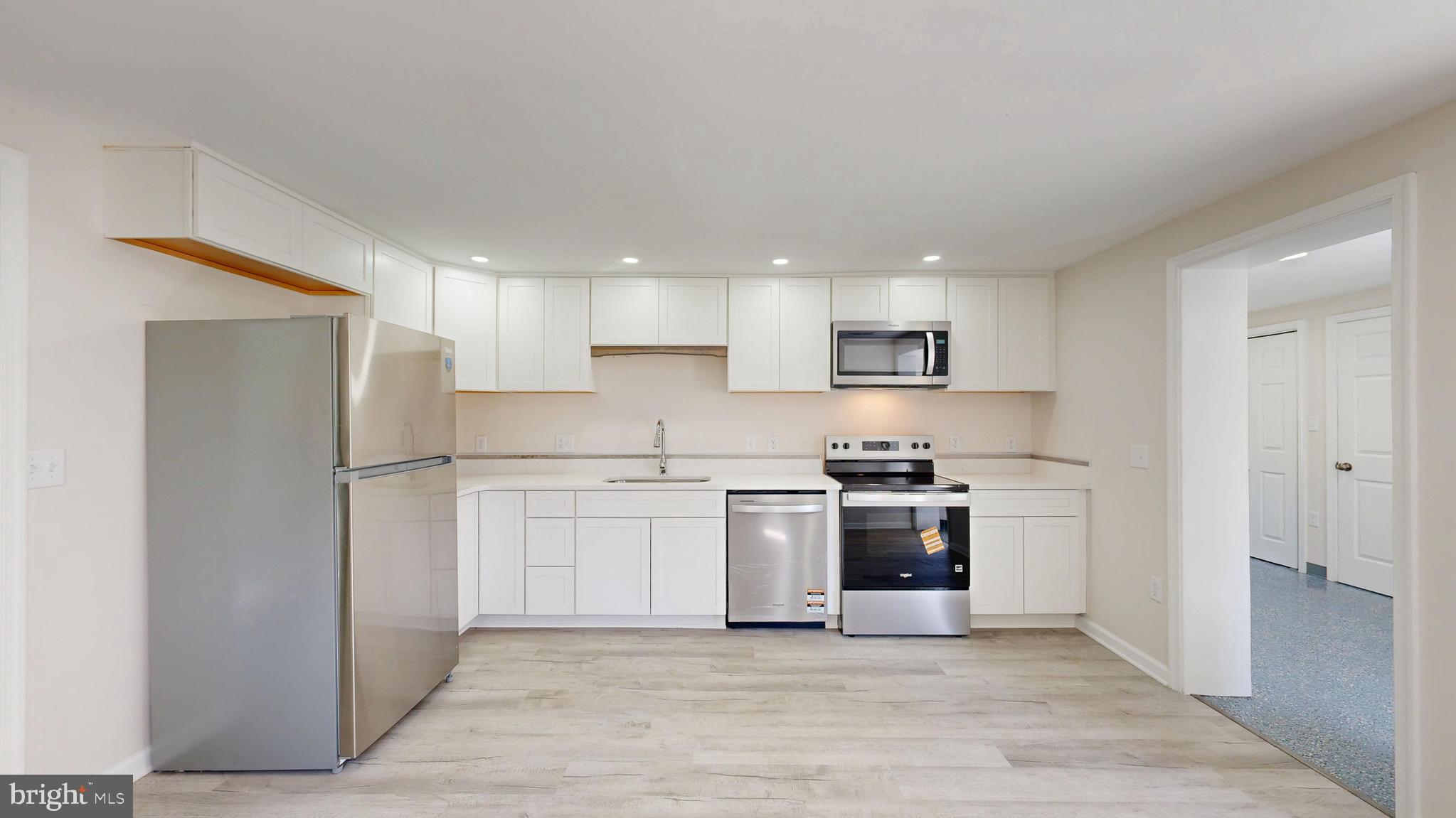4640 Mahan Corner Road Marydel, DE 19964 - Photo 4 of 29 a kitchen with stainless steel appliances granite countertop a stove and a refrigerator