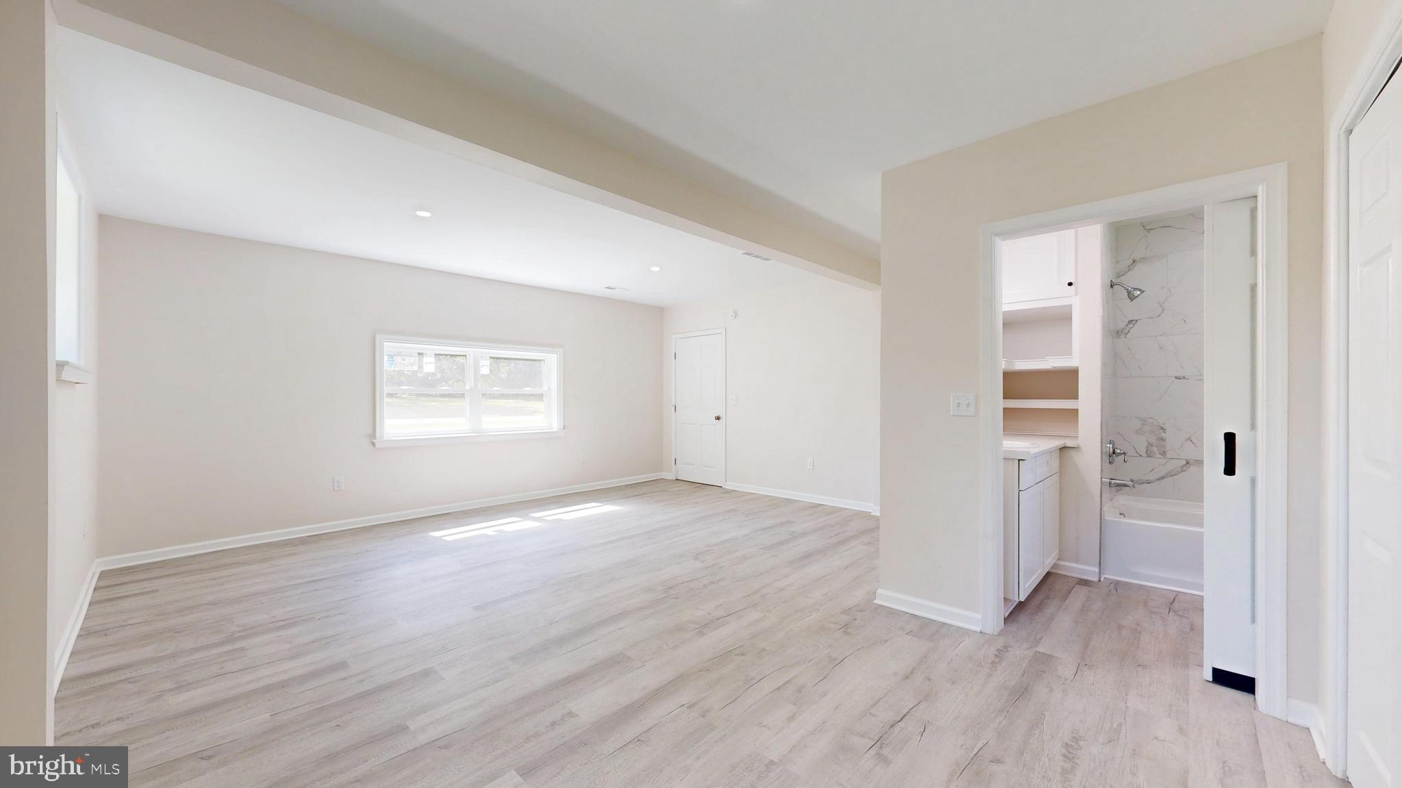 4640 Mahan Corner Road Marydel, DE 19964 - Photo 9 of 29 an empty room with wooden floor closet and windows