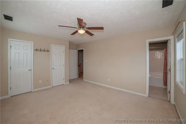 a view of empty room with ceiling fan