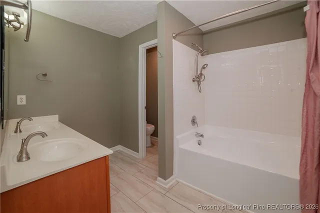 a bathroom with a bathtub and shower