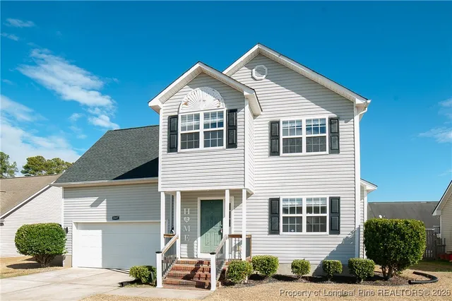 a view of residential houses with street