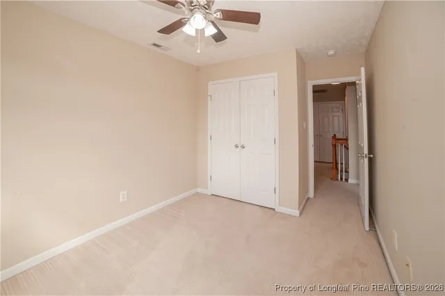 an empty room with chandelier fan