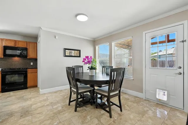 a dining room with furniture and window