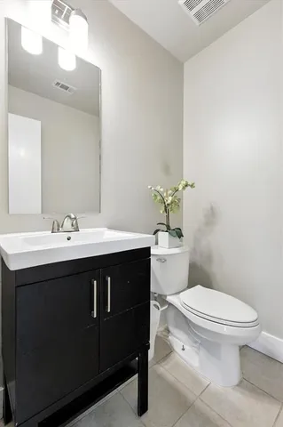 a bathroom with a sink vanity and a toilet
