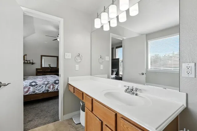a en suite bathroom with a double vanity sink and a mirror
