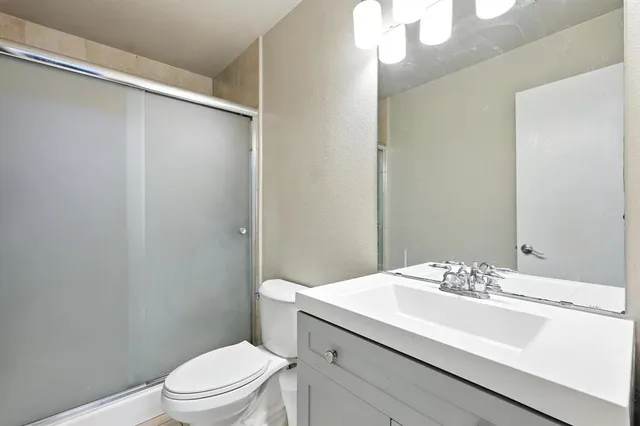 a bathroom with a sink toilet and vanity