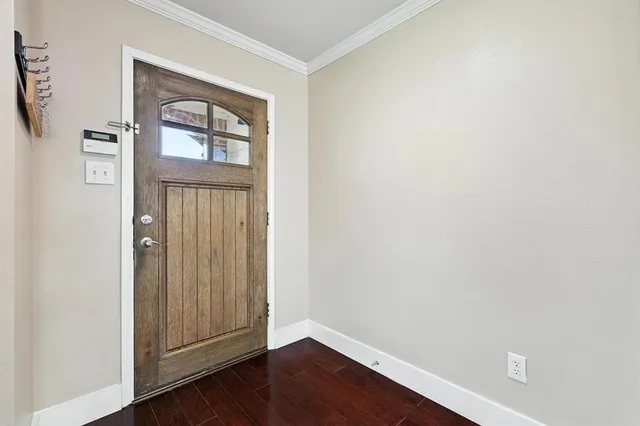 an empty room with wooden floor and a window